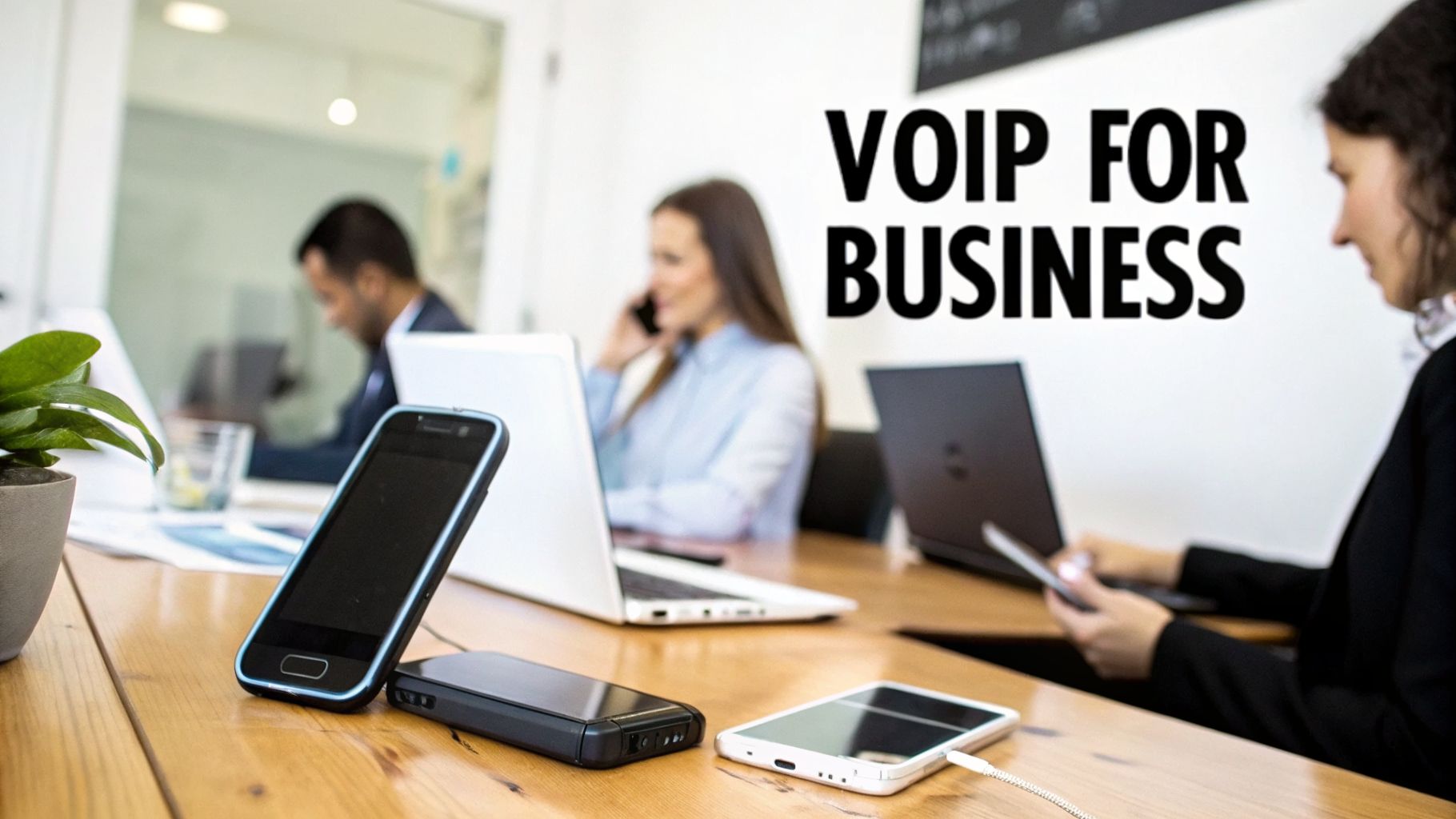 Professionals using laptops and mobile phones in a modern office, emphasizing VoIP for business communication.