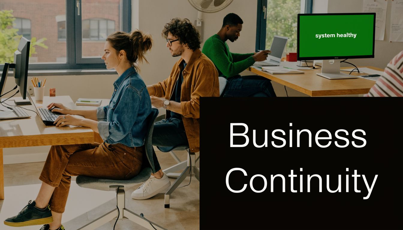 A diverse team of office professionals working collaboratively on their computers in a modern workspace setting.