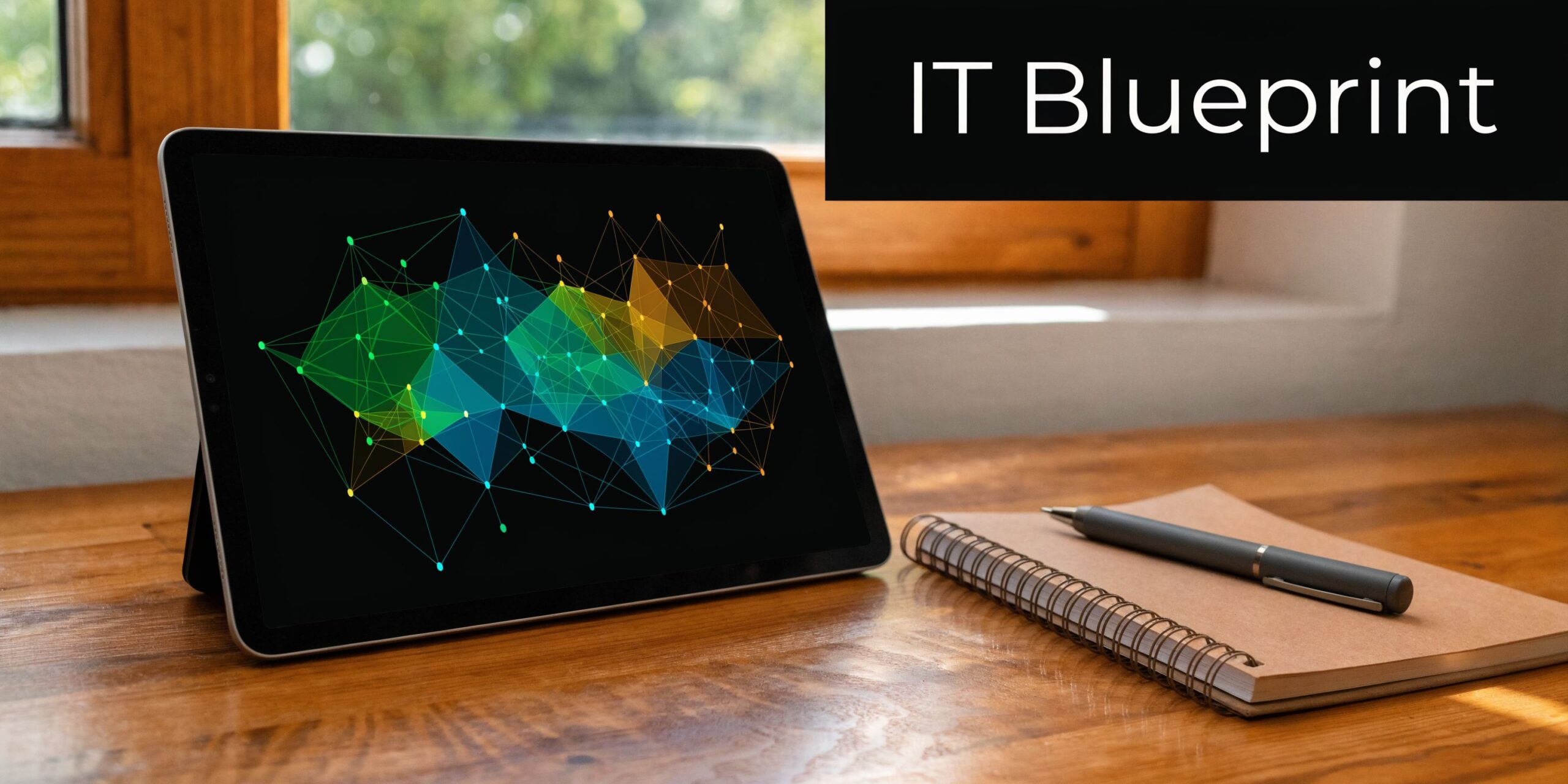 A digital tablet displaying a network data visualization sitting next to a notebook on a desk.