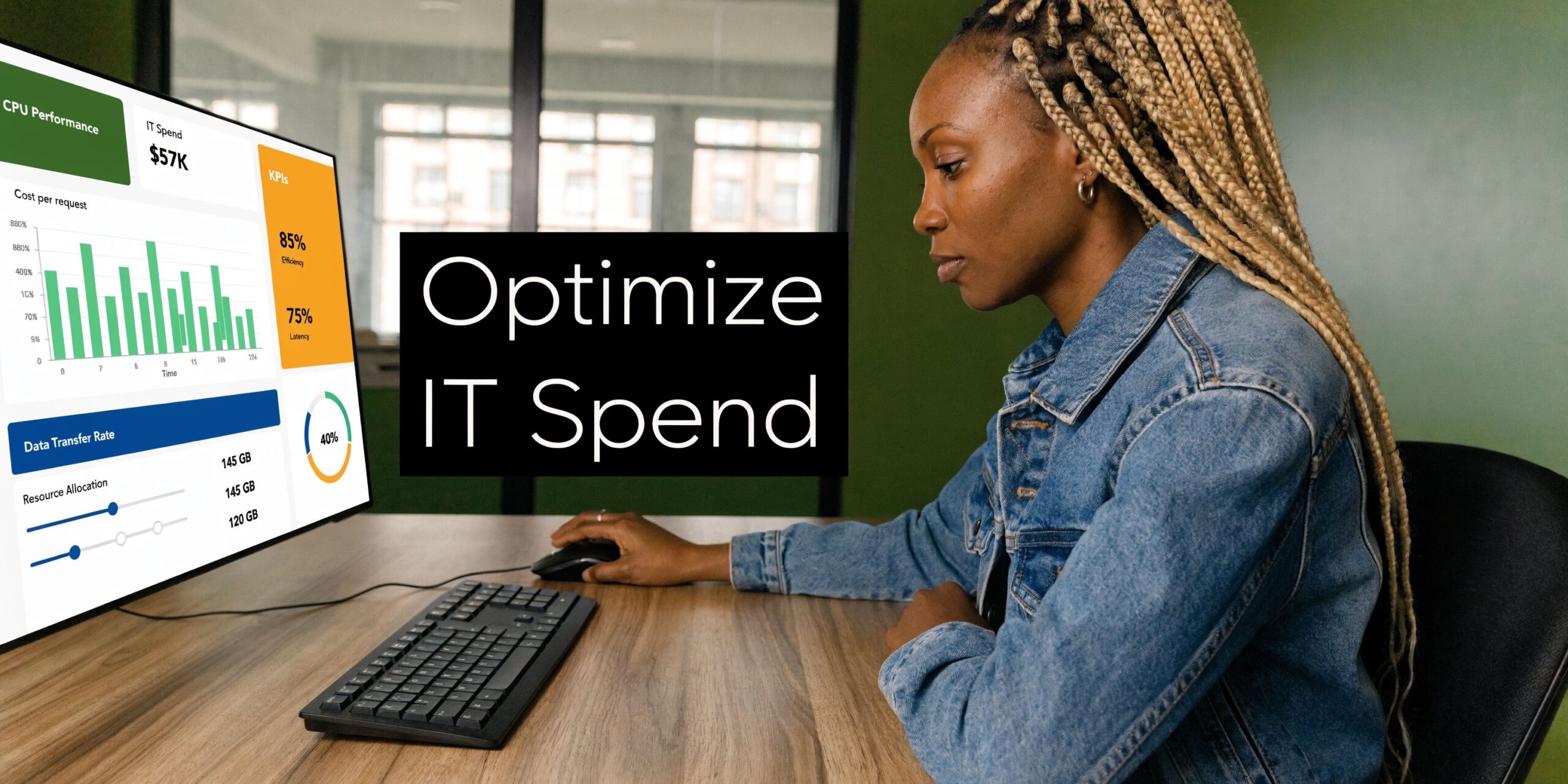 A woman with braided hair works at a computer desk viewing an IT performance dashboard on screen.